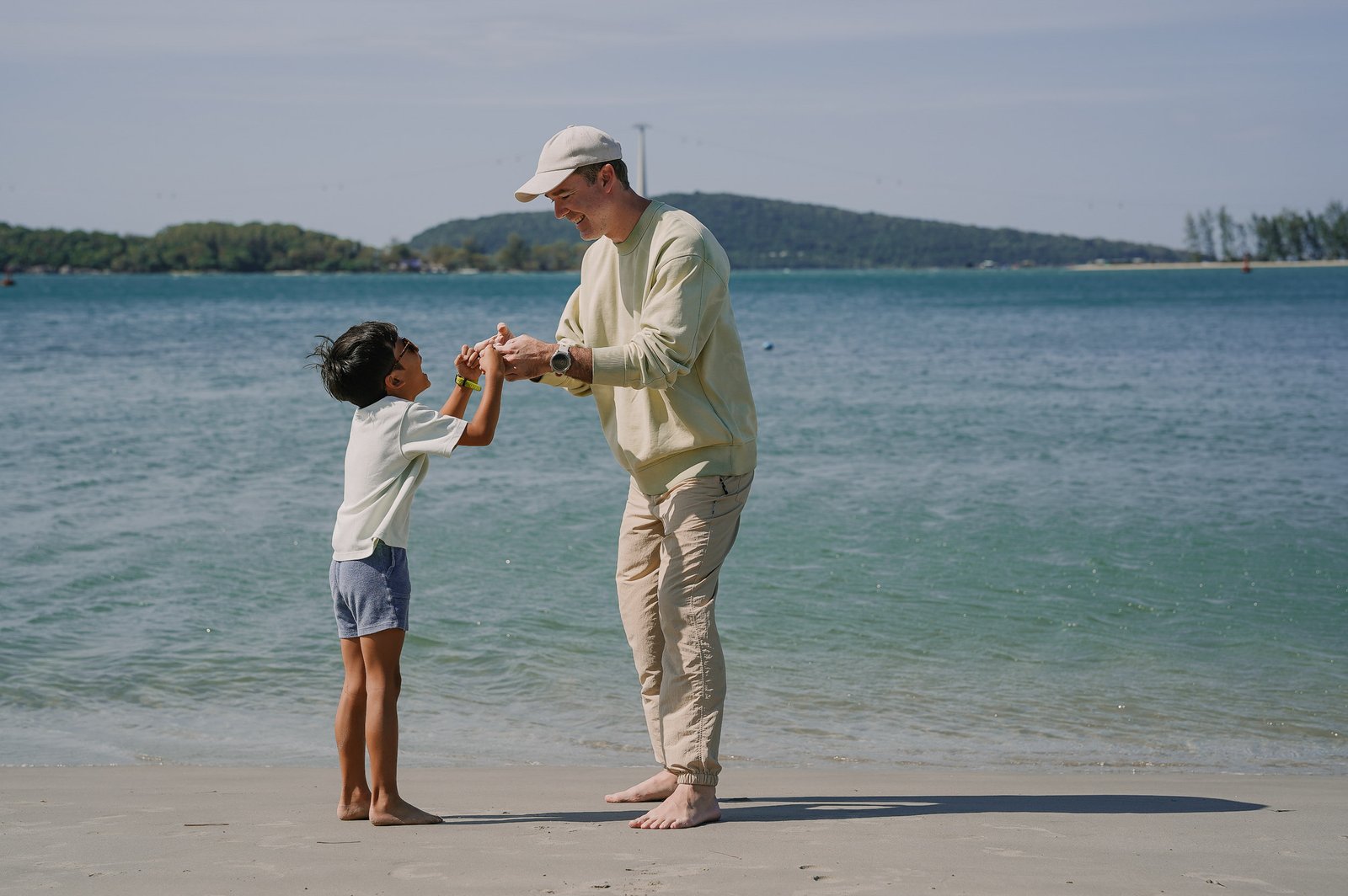 Family picture of father and son playing on the beach of Phu Quoc